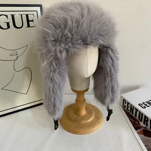 Close-up of gray faux fur trapper hat with windproof ear flaps and buckle detail