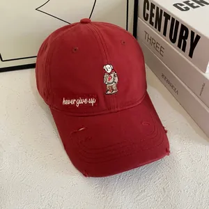 Deep red vintage cotton baseball cap with embroidered bear and distressed brim detail