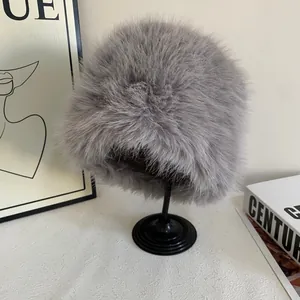 Plush grey faux fur bucket hat for winter warmth shown on a minimalist stand