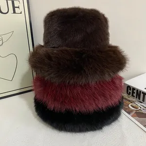 Close-up of fluffy faux fur bucket hats in dark brown, burgundy and black colors