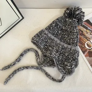Winter chunky knit pom-pom beanie with earflaps and long braided tassels in grey mix