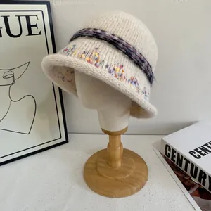 Detailed knit texture and floral embroidery on a vintage cream bucket hat for women