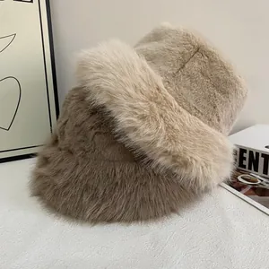 Plush faux fur bucket hats in beige and dark brown colors for winter warmth