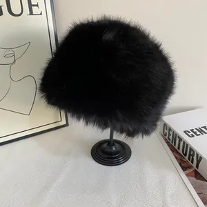 Close-up of black faux fur bucket hat with plush texture on a display stand