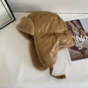 Brown quilted trapper hat with warm plush lining and adjustable ear flaps for winter