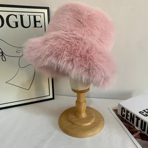 Detailed macro view of soft pink faux fur material on a winter bucket hat on wood stand