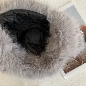 Close-up of grey faux fur trapper hat featuring warm quilted lining and soft texture