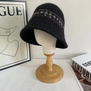 Detailed close-up of Fair Isle geometric knit pattern on a black warm bucket hat