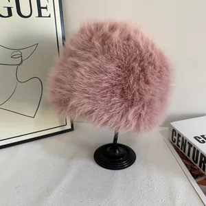 Pink faux fox fur bucket hat for women showing fluffy texture and plush winter design