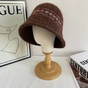 Detailed texture of brown Fair Isle knit bucket hat with colorful folk patterns on mannequin