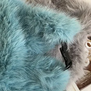 Detail of faux fur winter hat with blue and grey plush texture and plastic buckle strap