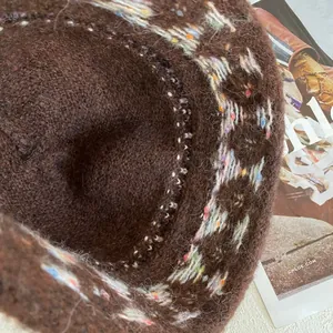 Detailed macro view of dark brown faux fur bucket hat with colorful jacquard knit patterns