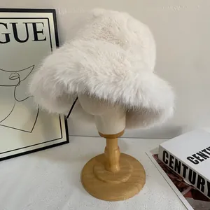 Detail of soft off-white faux fur bucket hat material on a wooden mannequin head display