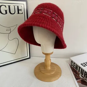 Close-up of red Fair Isle knit bucket hat with soft mohair wool and striped details