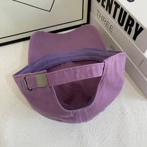 Detail of purple cotton baseball cap with adjustable metal buckle and strap