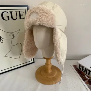 Detail of cream trapper hat with plush faux shearling lining and adjustable chin strap