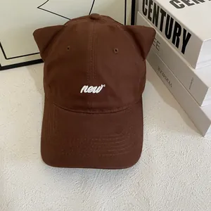 Detailed view of the dark brown baseball cap featuring 3D cat ears and new embroidery