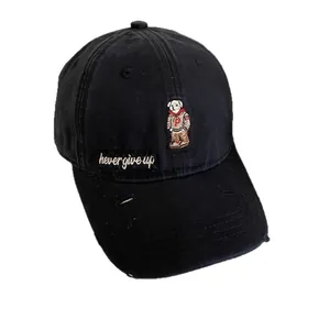 Black cotton baseball cap featuring embroidered bear and distressed brim details
