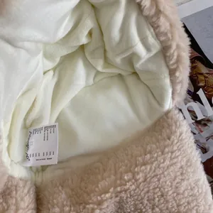 Detail of plush winter hat lining and wash care label with nylon polyester blend fabric