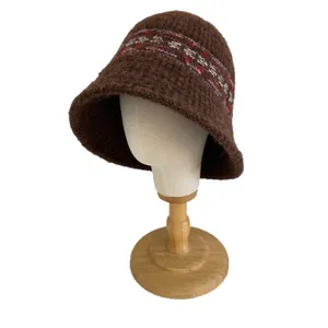 Brown Fair Isle knit bucket hat with vintage geometric pattern on a white mannequin head