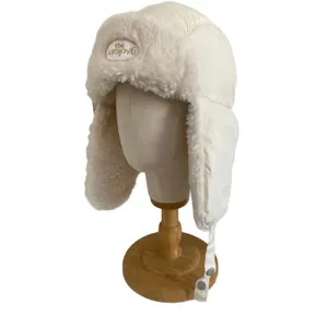 Winter plush trapper hat with thick fleece lining and ear flaps in cream white