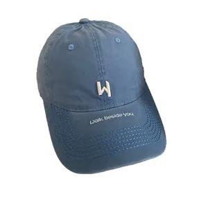 Blue cotton baseball cap with white W embroidery and Walk beside you brim detail