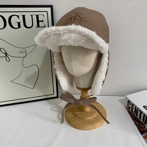 Detail of winter trapper hat with fleece lining, mountain embroidery and ear flaps