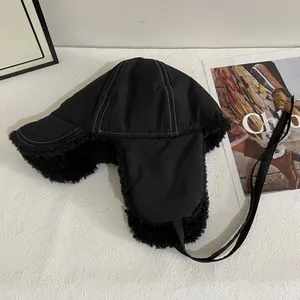 Detail of winter trapper hat showing windproof nylon shell and thick black sherpa lining