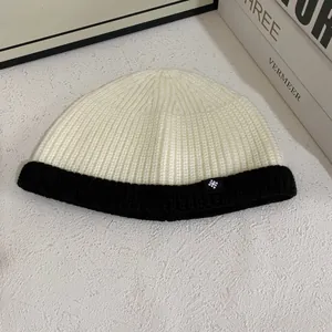 Close-up of contrast knit beanie texture with snowflake patch and ribbed cuff