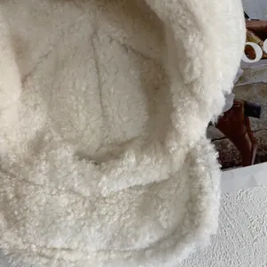 Detailed close-up showing soft plush texture and warm interior of the winter trapper hat