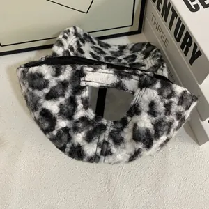 Detail view of plush black and white leopard print baseball cap with fuzzy texture