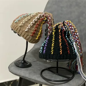 Brown and black knitted beanie with colorful tassel dreadlocks for trendy winter style