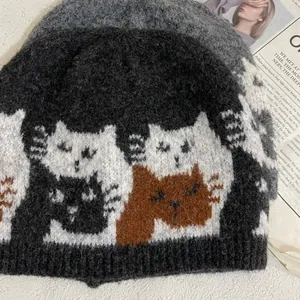 Detailed close-up of cat jacquard pattern on high-quality dark grey knitted beanie hat