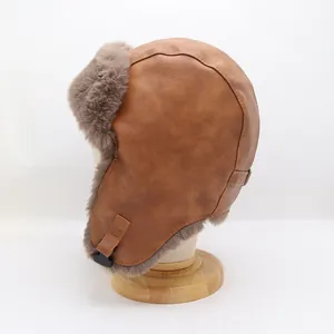 Detail showing the brown faux leather exterior and thick gray faux fur lining of the winter hat