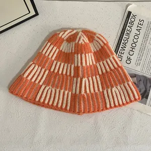 Chunky knit striped bucket hat in orange and beige, cozy autumn winter crochet style