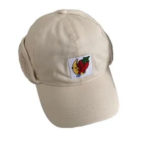 Beige winter baseball cap with ear flaps and cute strawberry embroidery for cold weather