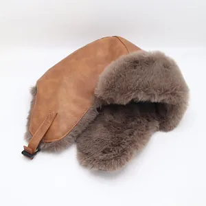 Detailed macro view of vintage brown leather trapper hat with warm thick faux fur lining