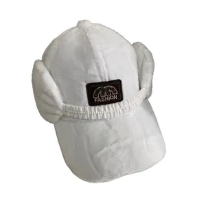 White faux fur ponytail baseball cap with earmuffs and gold fashion logo label