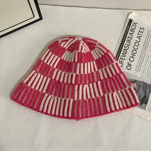 Detailed knit texture of pink and white striped crochet winter bucket hat in cozy style