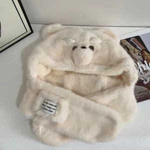 Detailed texture of beige plush bear ear hood with soft faux fur and embroidered face