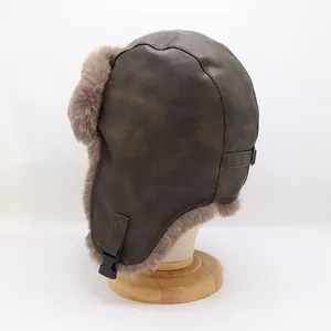 Detail of dark brown faux leather aviator hat with soft plush lining and buckle strap