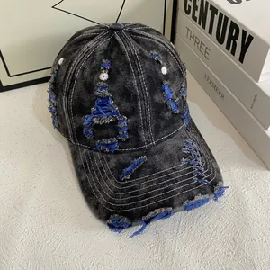 Vintage washed denim baseball cap with distressed blue ripped details and contrast stitching