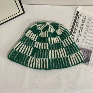 Detail of green and beige checkered crochet bucket hat with vintage woven texture