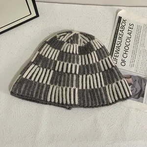 Detail of grey and white checkerboard knit pattern on a warm winter bucket hat