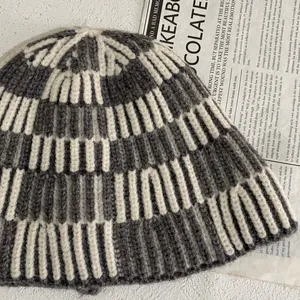 Detailed view of gray and white striped knit texture and thick ribbed weave of bucket hat