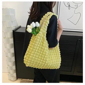 Detail of yellow bubble texture shoulder bag with tulip decor showing soft fabric capacity