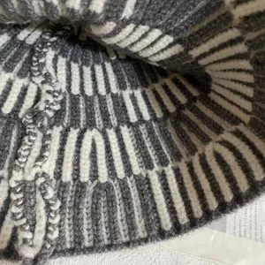Macro detail of vertical stripe knit pattern on gray and beige winter bucket hat