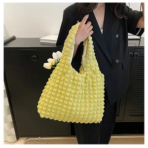 Macro view of bright yellow popcorn texture fabric on a stylish tote bag shoulder strap