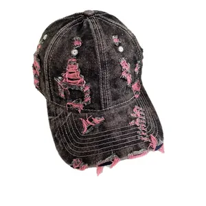 Distressed dark grey denim baseball cap with pink frayed edges and vintage ripped details