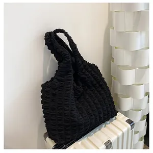 Detailed close-up showing the unique popcorn fabric texture of this black tote bag